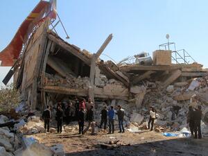 People gather outside the ruins of the MSF hospital in the Idlib province. (AFP/Ghaith Omran)