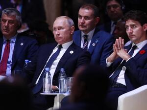 Kosovo's President Hashim Thaci (L), Russian President Vladimir Putin (C) and Canadian Prime Minister Justin Trudeau (R) attend the opening session of the Paris Peace Forum. (GONZALO FUENTES / POOL / AFP)
