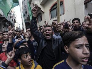 Palestinian demonstrators chant slogans before burning pictures of Israeli Defence Minister Avigdor Lieberman in front of the house of Ismail Haniya in Gaza on November 14, 2018. (AFP/File)