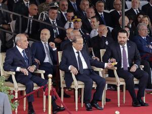 Lebanese Prime Minister Saad Hariri (C-R), President Michel Aoun (C) and House Speaker Nabih Berri (L) attend a military parade to celebrate the 75 th anniversary of Lebanon's independence in downtown Beirut, on November 22, 2018. (ANWAR AMRO / AA / AFP)