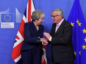 EU Commission President Jean-Claude Juncker shakes hands with Britain's Prime Minister Theresa May as she arrives for Brexit talks at the EU Headquarters in Brussels on November 24, 2018. (AFP)