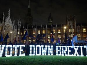 Anti-Brexit demonstrators protest outside Parliament with a giant "Vote Down Brexit" spelled out in illuminated letters. (AFP/ File)
