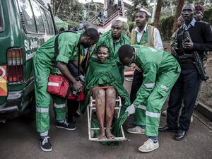 An injured woman is evacuated from the scene of an explosion at a hotel complex in Nairobi's Westlands suburb on January 15, 2019, in Kenya. (AFP)