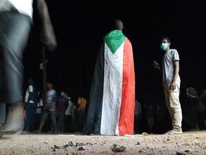A Sudanese demonstrator wears a national flag during an anti-government protest in the Haj Yousef neighbourhood of the Bahari district in the capital Khartoum. (AFP/ File)