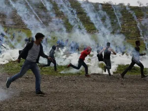 Palestinian demonstrators run away from tear gas fired by Israeli troops during a protest against Jewish settlements, in al-Mughayyir village near Ramallah, in the Israeli-occupied West Bank, on February 1, 2019.(AFP)