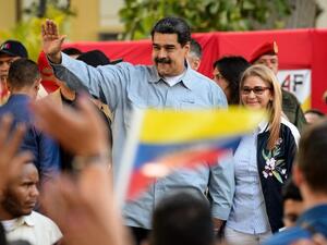 Venezuelan President Nicolas Maduro (L) delivers a speech next to his wife Cilia Flores, on the signature campaign he launched to put a halt to intervention threats against his government. (AFP)