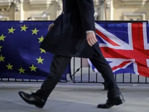 A man walks past the flags of Anti-Brexit protesters outside the Houses of Parliament in London on February 12, 2019. (AFP/ File)