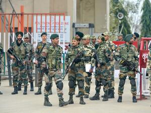 Indian security forces stand guard near the India-Pakistan border in Wagah on March 1, 2019, as they wait for the return of an Indian Air Force pilot being returned by Pakistan. (AFP/File)