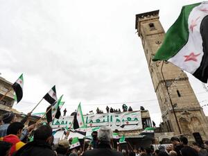 Syrians demonstrate with opposition flags in the square of the Great Mosque of the city of Maaret al-Numan in the south of the mostly rebel-held Idlib province on March 15, 2019. (AFP/ File Photo)