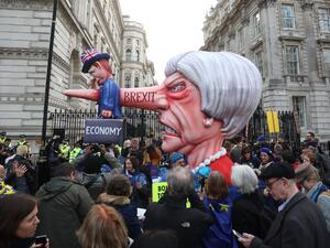 A puppet head of Britain's Prime Minister Theresa May spearing a representation of the British Economy is positioned on Whitehall outside Downing Street. (AFP/ File)