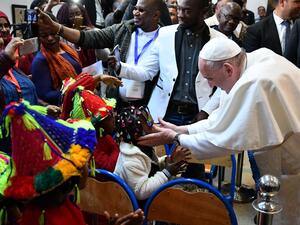 Pope Francis greets children during his visit to a centre run by the Catholic humanitarian organisation Caritas, which hosts migrants, in the Moroccan capital Rabat. (AFP/ File)