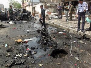Iraqi security forces inspect the scene of a car-bomb blast targeting Shiite pilgrims on an annual march to a Baghdad. (AFP/ File Photo)