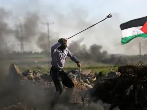 Palestinian protesters hurls a rock at Israeli security forces during clashes near the Shejaiya area of Gaza City . (AFP/ File)