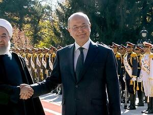 Iranian President Hassan Rouhani shakes hands with his Iraq counterpart Barham Salih in Tehran on Saturday morning. (AFP/ File Photo)