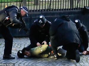 The man was later pinned down to the ground while armed officers surrounded him, with one pointing a gun at his head. (AFP/File)