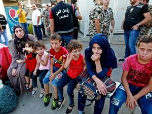 Syrian refugees gather as they prepare to leave the Lebanese capital Beirut, before their journey to return home to Syria. (AFP)
