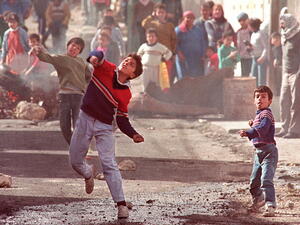 Palestinians throw stones in Ramallah as part of the 1st 1987 Intifada. (AFP)