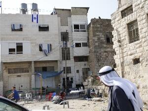 Palestinians walk past a house occupied by a group of Israeli settlers the previous day in the divided West Bank town of Hebron. (AFP)
