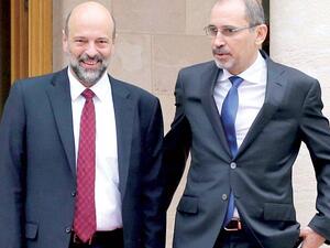 Jordan’s Foreign Minister Ayman Safadi (R) and Prime Minister Omar Razzaz at the Jordanian Royal Palace in Amman. (AFP)