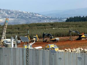 Israeli soldiers deploy excavators alongside the border wall with Lebanon on December 5, 2018. (AFP/File)