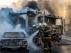 A firefighters putting out a burning truck and car during a wave of gang violence in Brazil’s northeastern city of Fortaleza, Ceara State, on January 3, 2019. (AFP)