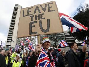 Protesters hold up placards and Union flags as they attend a pro-Brexit demonstration. (AFP/ File)