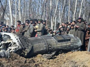 Soldiers and Kashmiri onlookers stand near the remains of an Indian Air Force aircraft after it crashed in Budgam district on the outskirts of Srinagar on Wednesday February 27th. (AFP/ File)