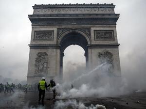 Demonstrators clash with riot police at the Arc de Triomphe during a protest of Yellow vests. (AFP/File)