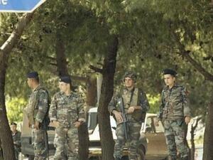 Soldiers stand guard on the road leading to Mieh Mieh Palestinian refugee camp following clashes occurred between two different Palestinian factions. (AFP/File)