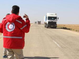UN and Syrian Arab Red Cross (SARC) aid convoy drives into Rukban camp last November (AFP/File photo)