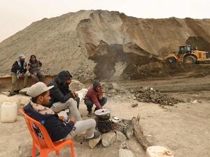Unemployed Tunisians sit at a phosphate production plant in Kef Eddour. (AFP)