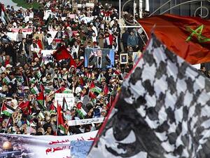 Pro-Palestinian protesters wave Palestinian and Moroccan flags during a demonstration in Rabat. (AFP/ File Photo)