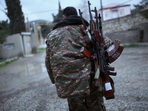 A soldier of the self-defense army of Nagorno-Karabakh carries weapons in Martakert. (AFP/File)