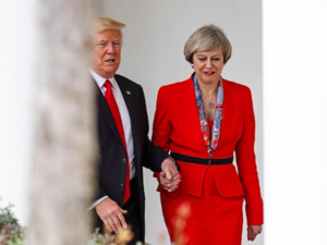 Donald Trump and Theresa May hold hands as they stroll in the White House in a January 2017 visit by the British Prime Minister to Washington. (AFP/Getty Images) 