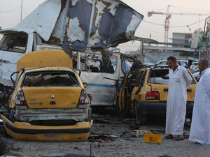 Two men inspect the aftermath of a Baghdad suicide bombing. (AFP/File)
