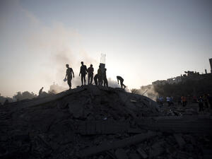 Palestinians inspect a damaged building after an Israeli military strike in Gaza City. (AFP/File)