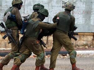 Israeli soldiers carry a Palestinian after he was detained during clashes in the West Bank city of Bethlehem on November 6, 2015. (AFP/File)