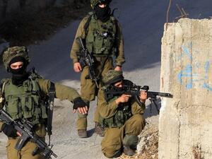 Israeli soldiers hold a position in a street, east of the West Bank city of Nablus, on 3 October 2015. (AFP/File)