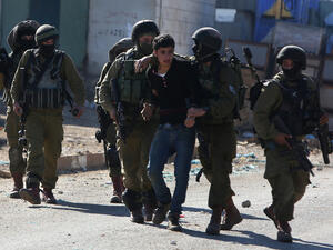 A Palestinian youth was arrested by Israeli police in Qabatiya on 4 February. (AFP/File)