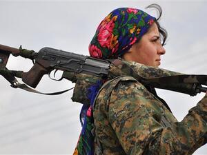 A Kurdish female fighter of the People's Protection Units (YPG) looks on at a training camp near the Syrian-Turkish border on February 13, 2015. (AFP/File)