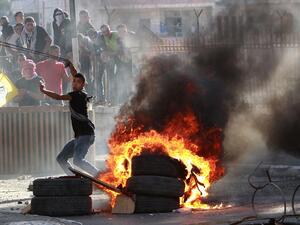 A file photo of a Palestinian youth throwing stones. (AFP/File)