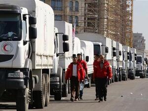 A Red Crescent convoy prepares to leave the Syrian capital Damascus to the besieged areas of Aleppo. (AFP/File)
