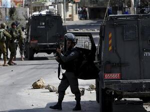 An Israeli trooper takes position during clashes with Palestinians in Arroub refugee camp, (AFP/File)
