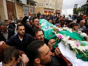 Relatives and friends chant slogans during the funeral of Abdul Fatah al-Sharif in Hebron. (AFP/File)
