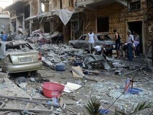Syrians look at the damage in the Syriac Quarter of the regime-held area of Aleppo, following a rocket attack by rebels, on July 11, 2016. (AFP/File)