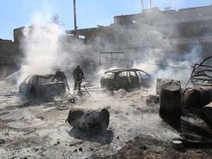 Syrian fire fighters put out a blaze at the scene of a reported barrel bomb strike. (AFP/File)