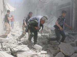 An injured man is evacuated from the aftermath of an air strike in the al-Qatarji area of Aleppo on Friday. (AFP/Ameer Alhalbi) 