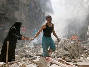 People walk amid the rubble of destroyed buildings following a reported air strike on the rebel-held neighbourhood of al-Kalasa in Aleppo, Syria on April 28, 2016. (AFP/Ameer Alhalbi)