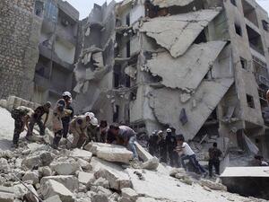 Amid claims of barrel bombs and cluster munitions being used, the French and British foreign ministers are denouncing 'war crimes'. (AFP/File)