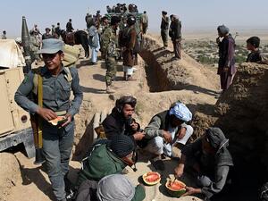 Anti-Taliban armed Afghan fighters eat watermelons on their outpost on a hilltop during a patrol against Taliban insurgents at Qara Ghoily in Almar district of northern Faryab province in this photo taken on Oct 16, 2015. (AFP/File)